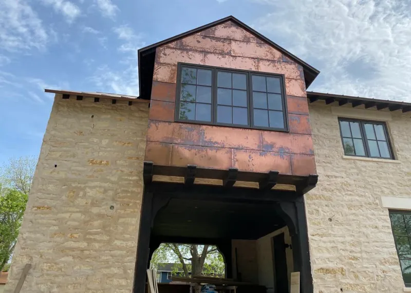 Copper metal panel facade on a stone building for Skylight Installation in West Pennsboro